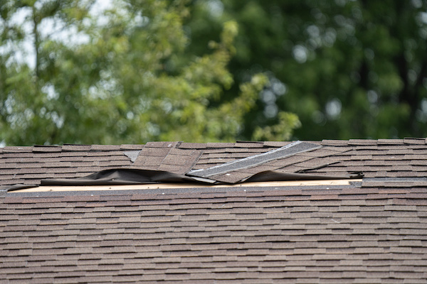 close view of torn off asphalt shingles