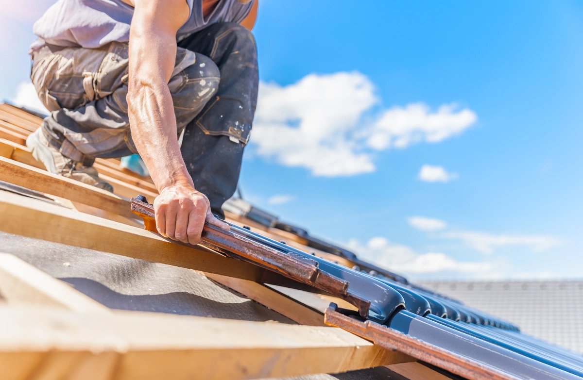 close up to placing roofing tiles