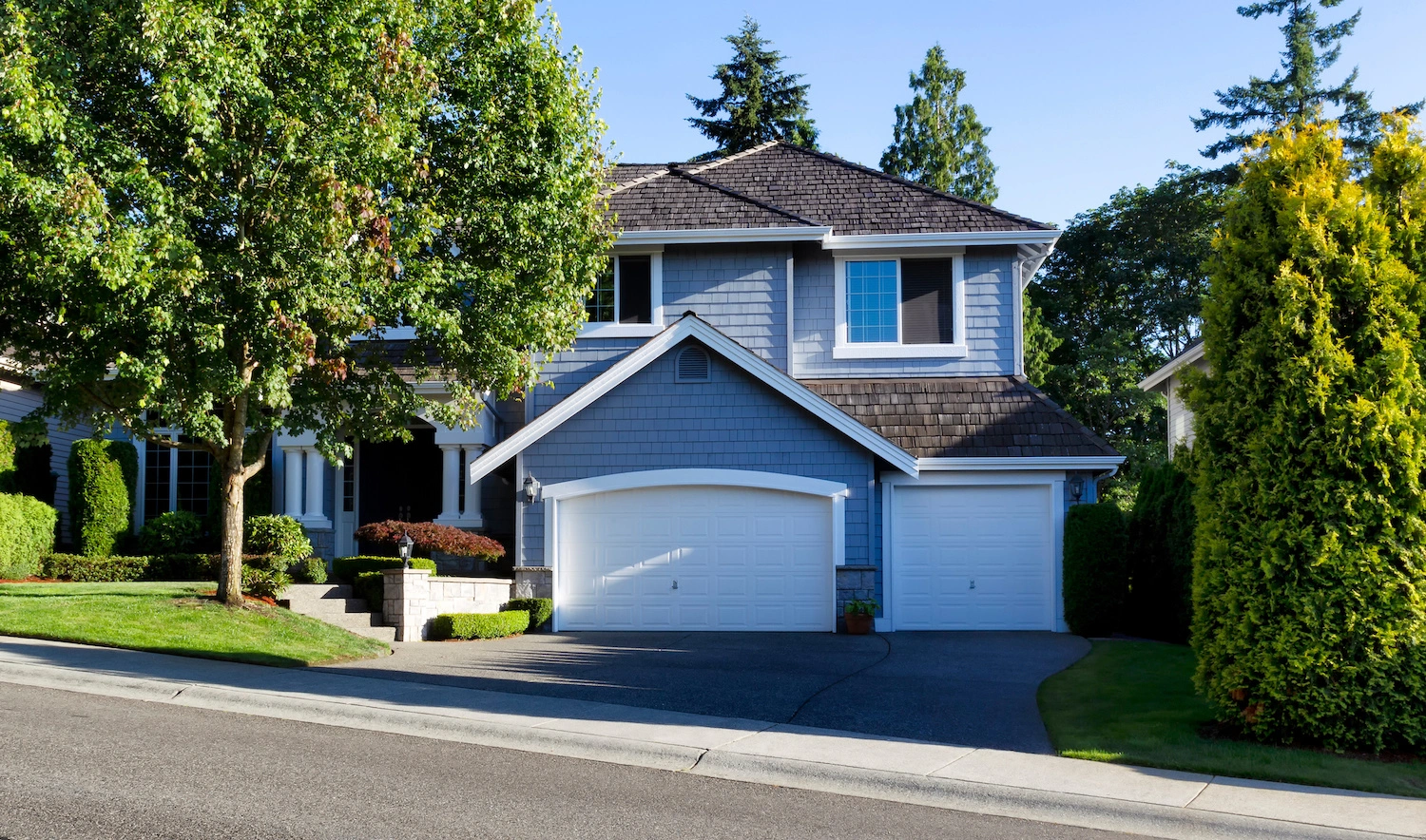 front of home with cedar shake shingles and blue siding