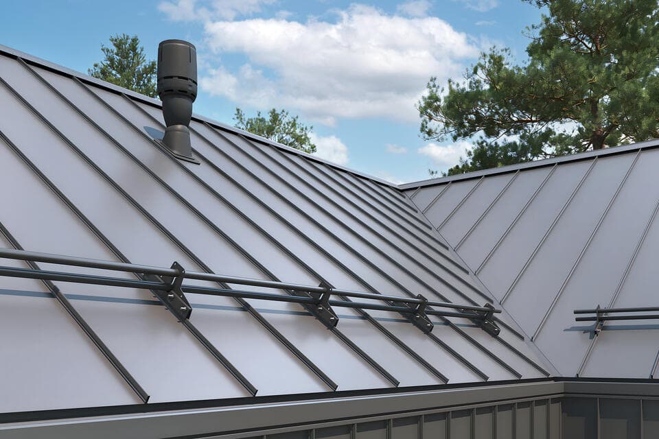 close up gray standing seam metal roof with snow rails