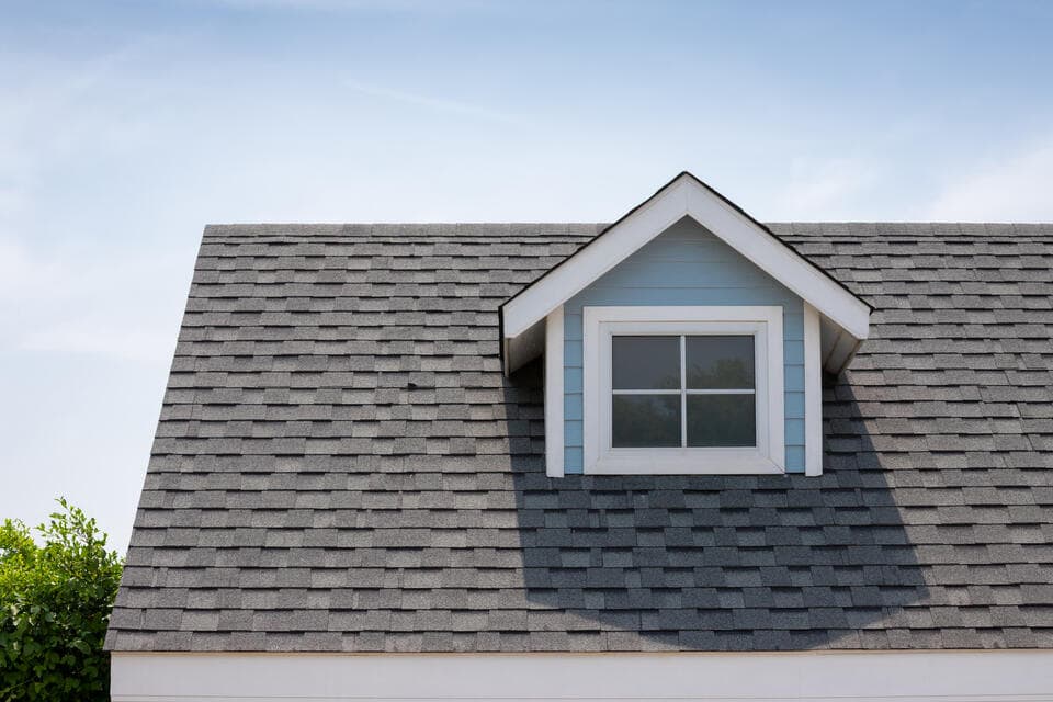 polson storm damage roof repair-gray architectural shingles on a blue sided house after storm damage repairs