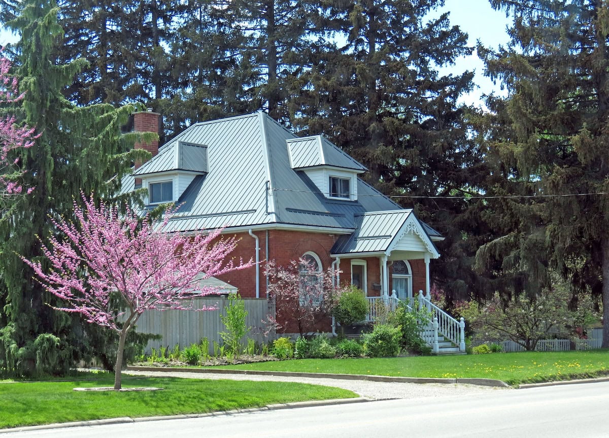 Metal roof on small, charming brick house