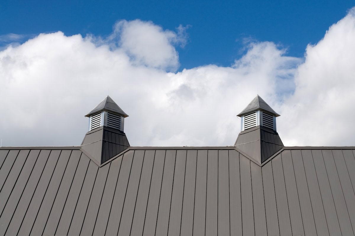 Grey Roof Vents with Blue Sky and Puffy White Clouds