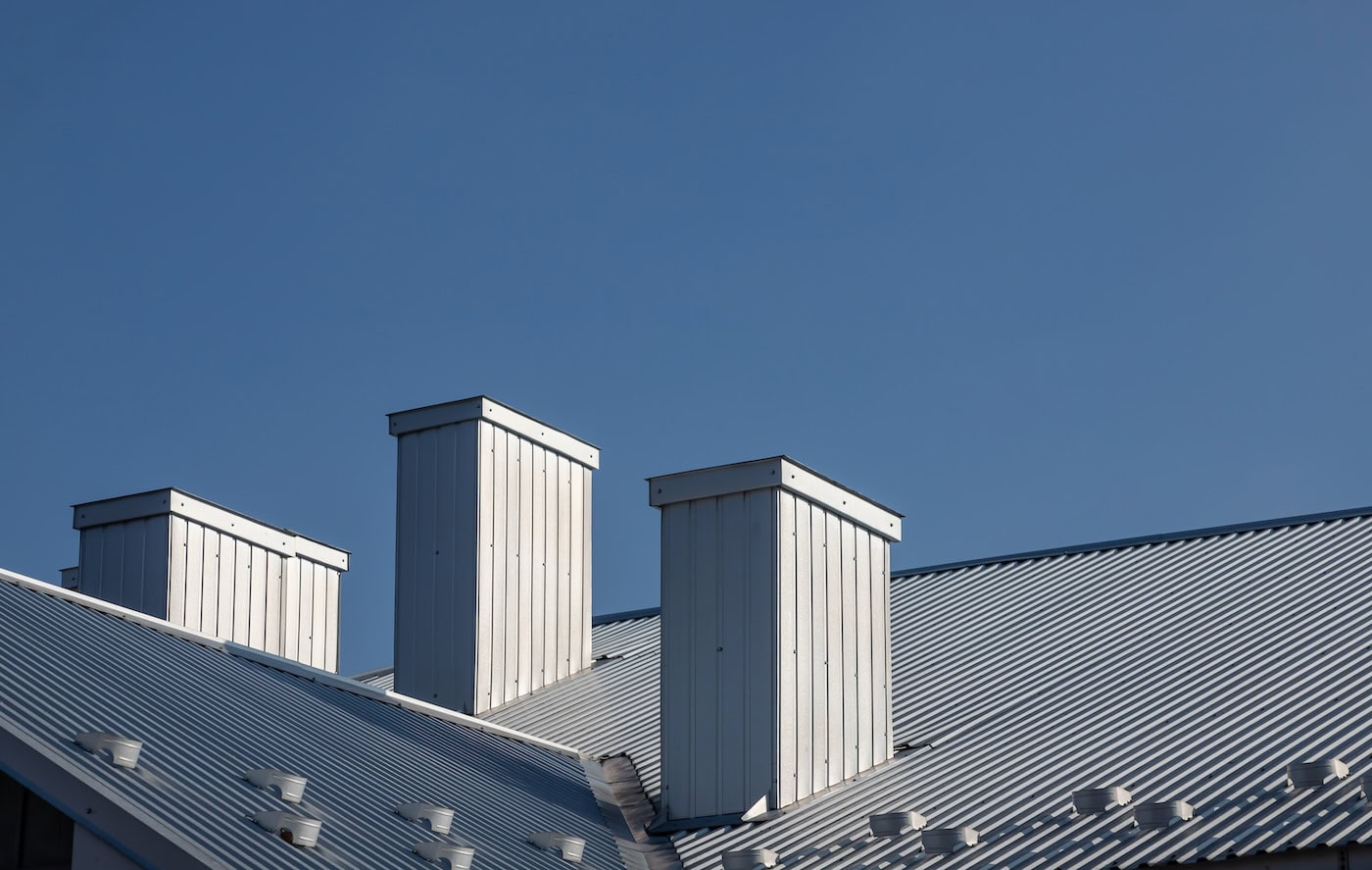 The roof of the house is made of red metal tiles, a beautiful large chimney.