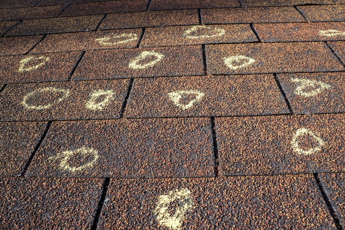 hail damage vs blistering blog post: Insurance adjuster marked the hail damage on a insureds roof.