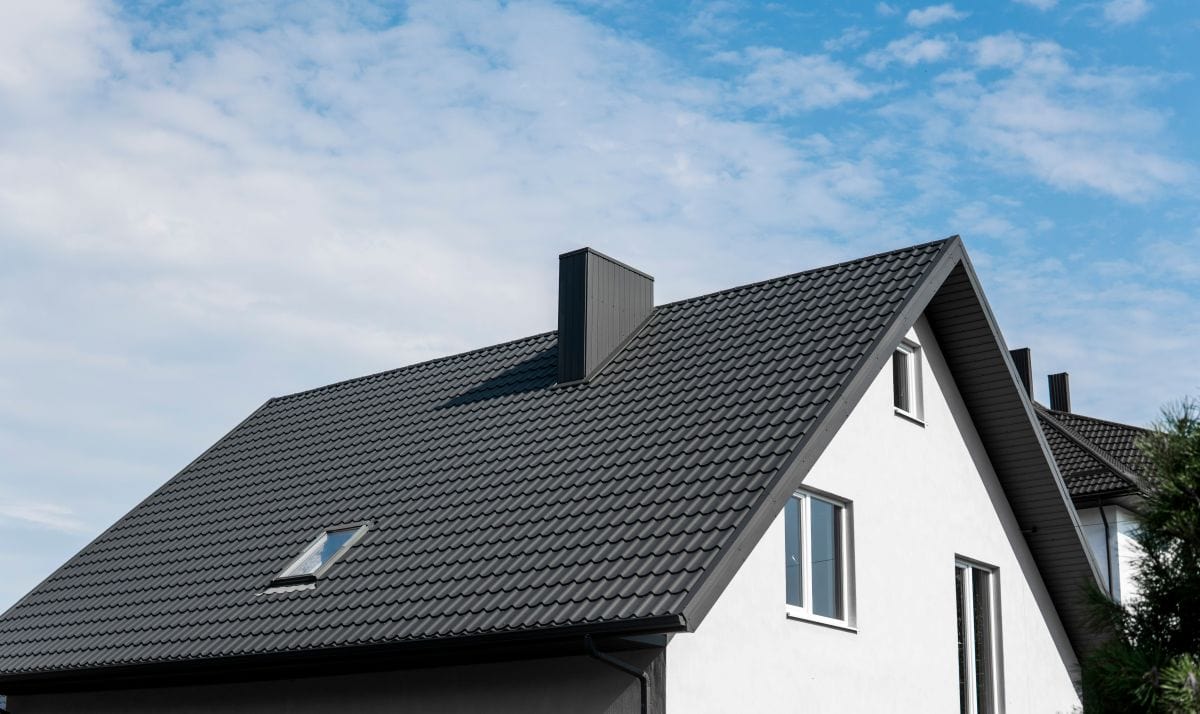 white house with metal tile roof