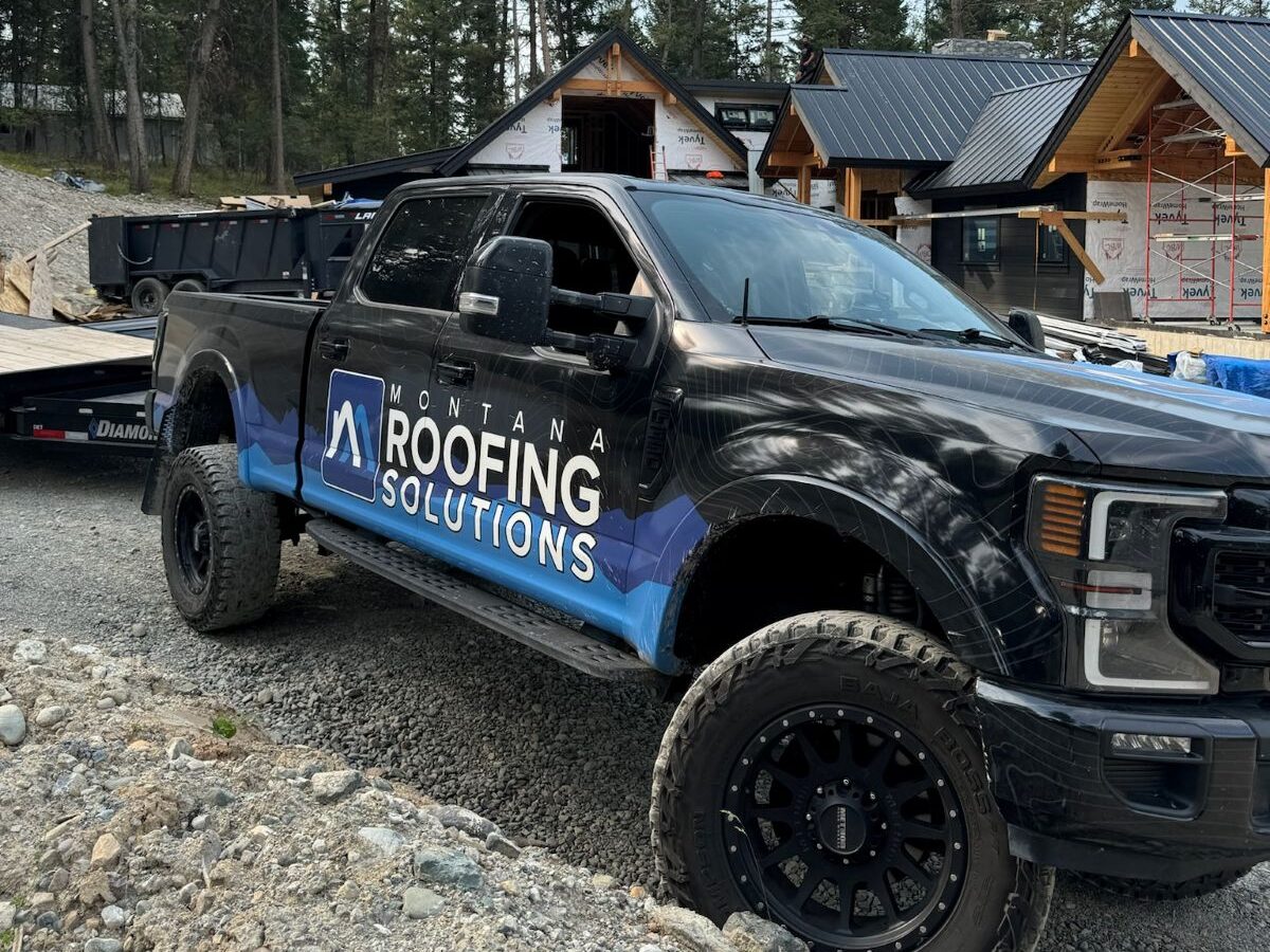 roof insurance claim truck in front of house
