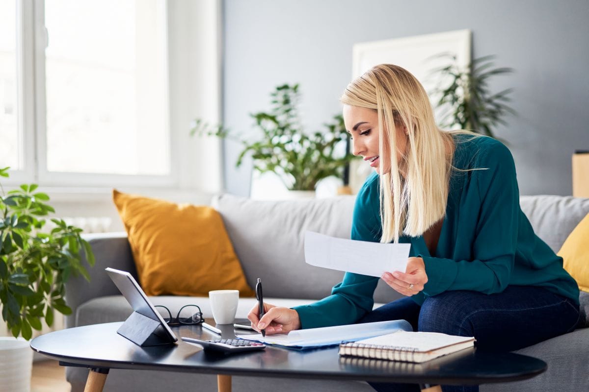 roof insurance claim blonde woman smiling filling papers