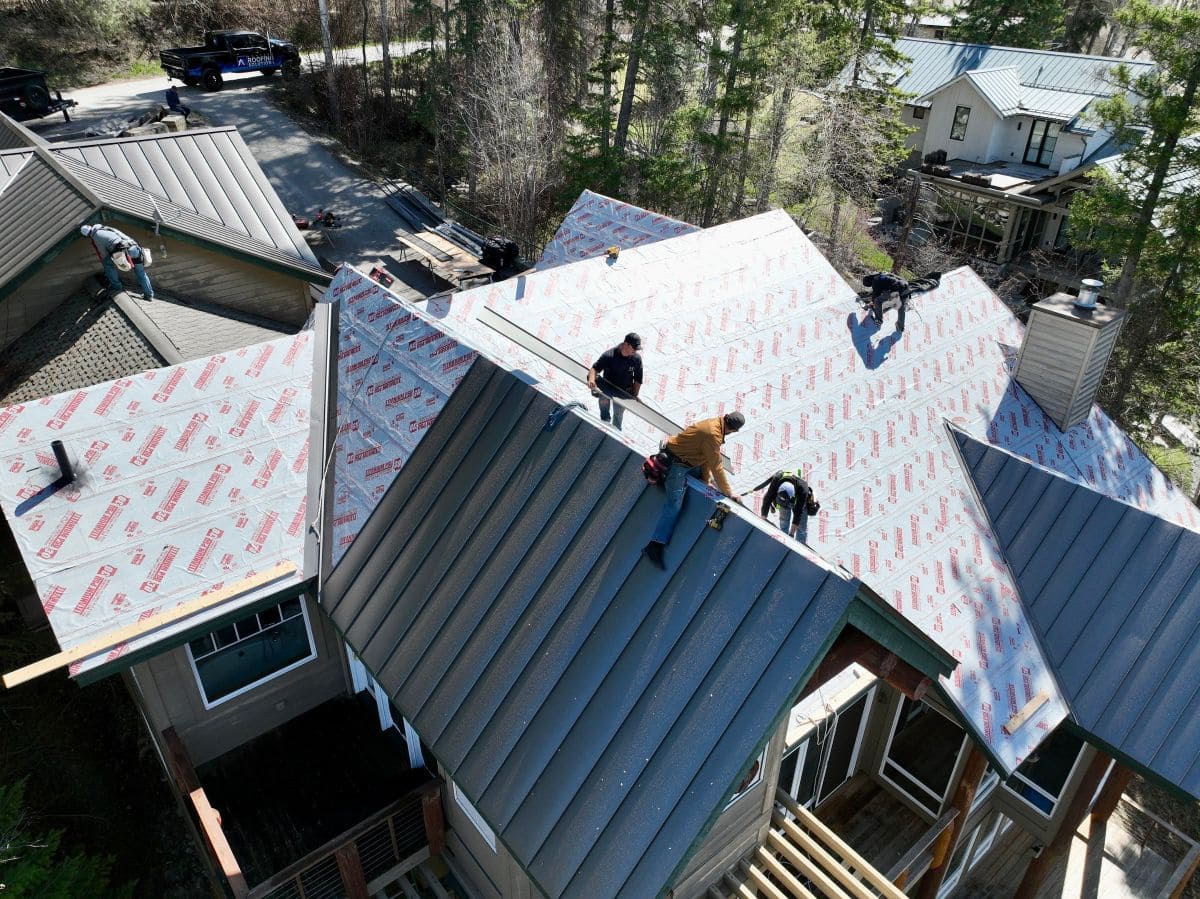metal roofing pros and cons Montana Roofing working on replacing metal roof
