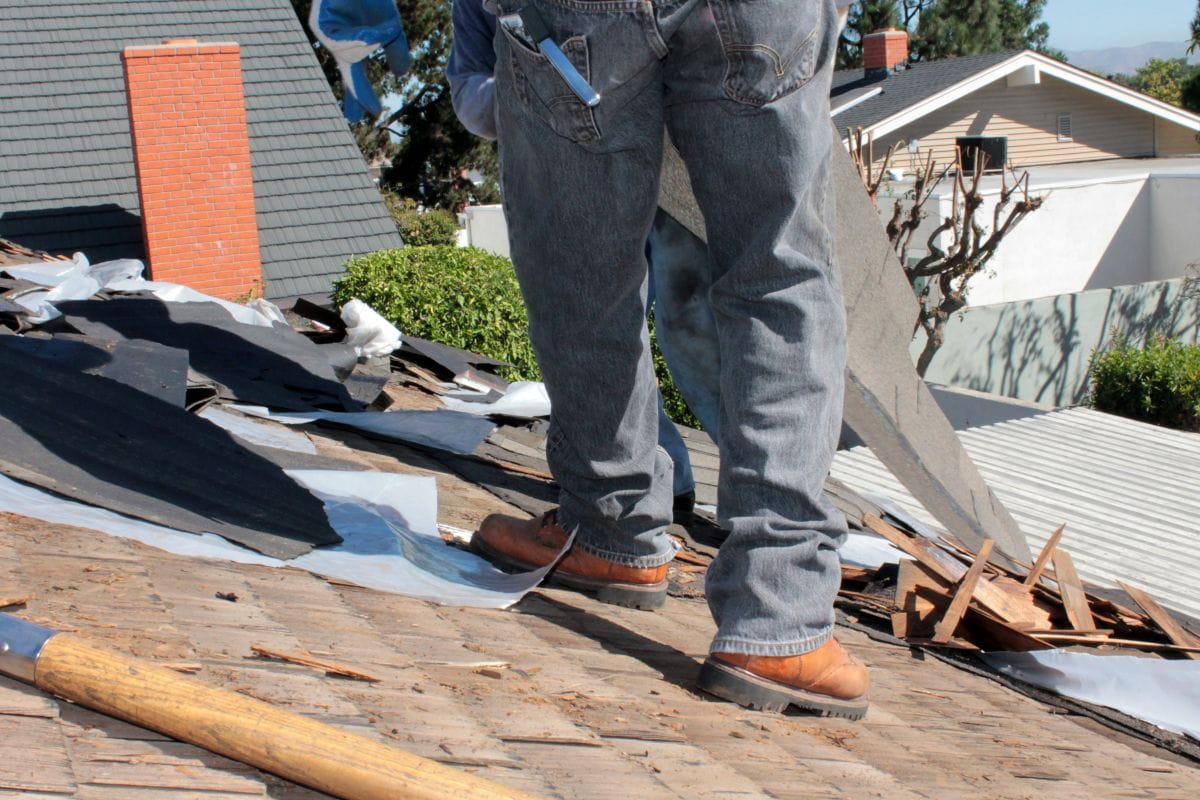 wood roof worker installing new cedar shake tiles